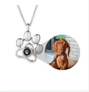 Real pawprint projection necklace shown with a dog photograph reveal