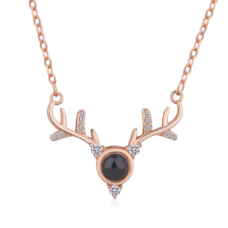 Real rose-gold-tone antler necklace shown with its projection lens