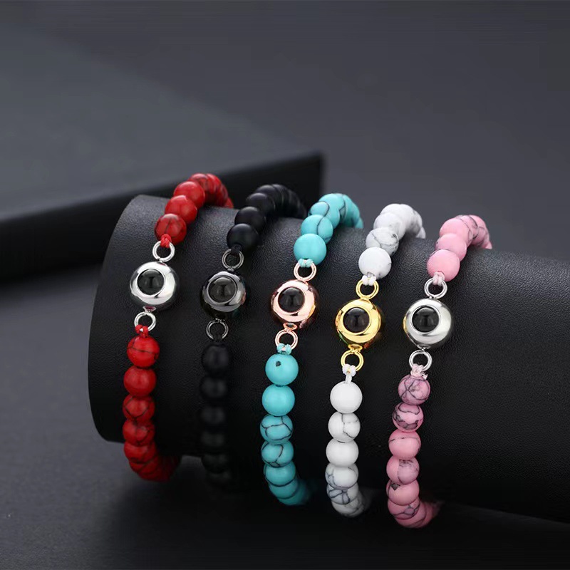 Real dark bead bracelet with a discreet cylindrical projection centerpiece